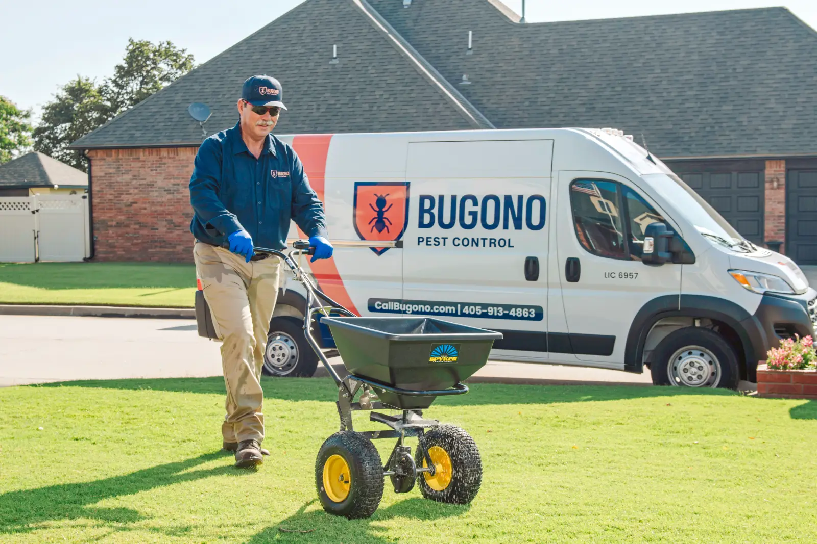 Bugono tech performing flea and tick treatment to Oklahoma City lawn